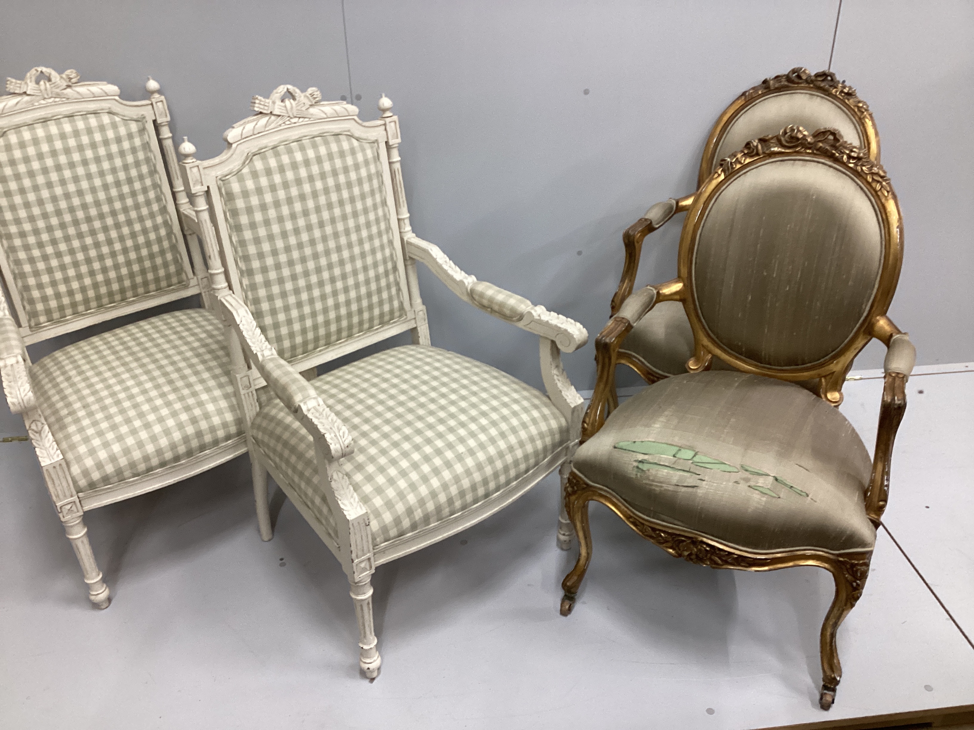 Two pairs of Louis XVI style painted and giltwood fauteuils, larger width 59cm, depth 52cm, height 104cm